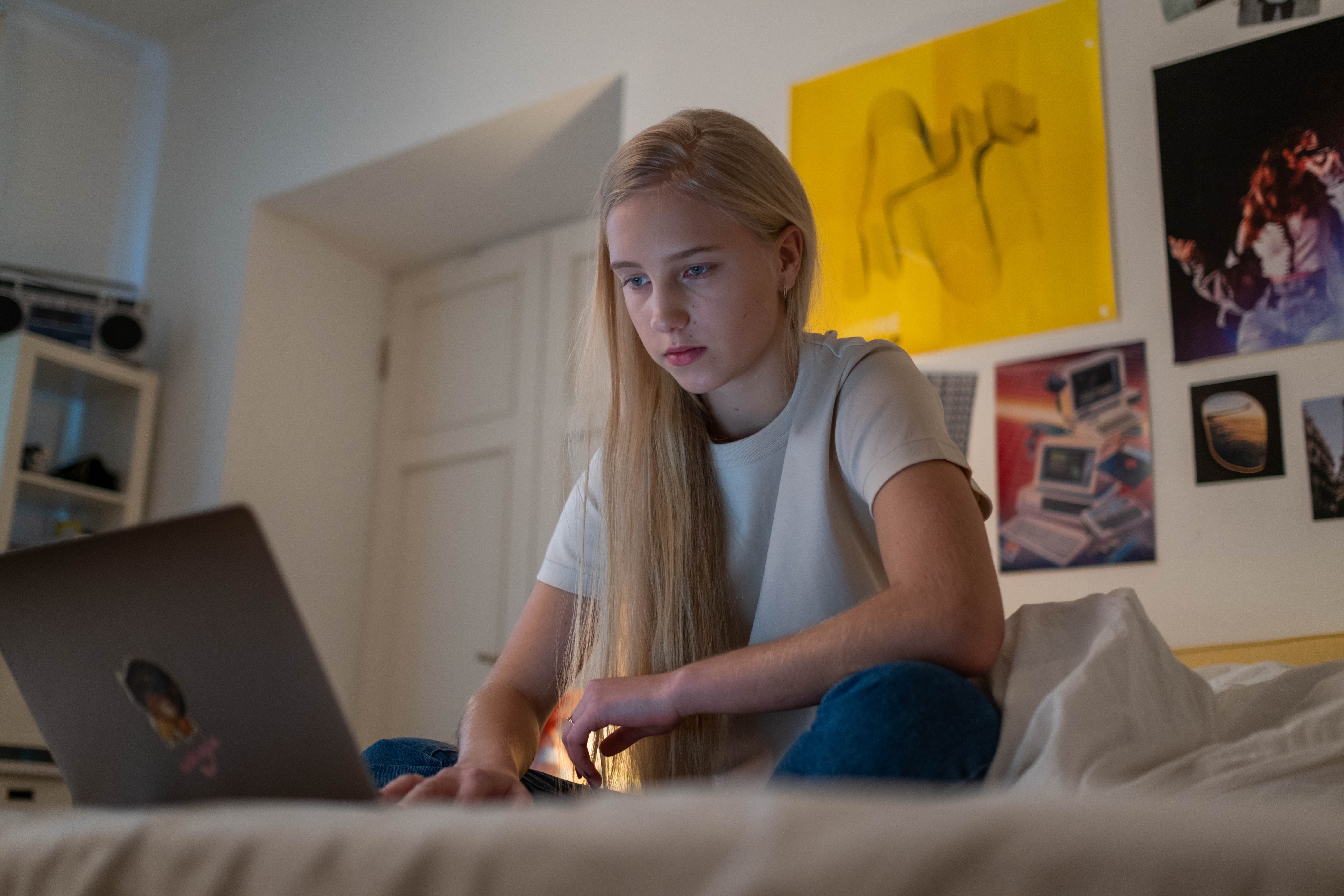 Teen girl looking at laptop computer